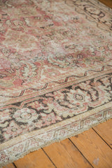 Distressed Persian Mahal carpet with worn floral patterns, revealing the foundation and hues of pale raspberry, blush, and ivory.