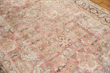 Decorative distressed field of vintage Mahal carpet with faded raspberry and ivory florals.