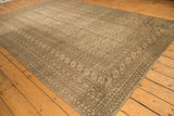 Distressed vintage Bokhara rug corner with intricate borders and tone-on-tone gul motifs.