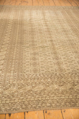 Vintage distressed Bokhara carpet corner showcasing many minor borders and tone-on-tone gray guls.