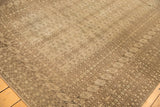 Geometric patterns within multiple minor borders on a tone-on-tone distressed Bokhara rug.