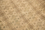 Distressed Bokhara carpet with geometric gul medallions and soft tone on tone colors.