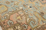 Distressed Mehrivan carpet with even wear, faded apricot, pale ocean green, and gold floral motifs.