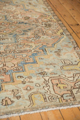Distressed Persian Mehrivan carpet detail: faded apricot, ocean green-blue floral vinery, even wear.