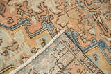 Distressed Mehrivan rug corner, displaying worn apricot, blue pile, and sturdy hand-knotted foundation.