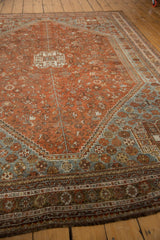Distressed Shiraz carpet corner with chestnut, dusty slate, powder blue floral borders.