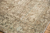 Distressed Mehrivan carpet section showing geometric florals, subtle seafoam, and faint foundation.