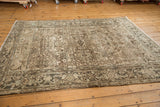 Distressed vintage Mehrivan rug corner, revealing muted geometric field and classic turtle border.