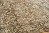Detailed view of distressed Mehrivan rug with geometric floral motifs and turtle border.