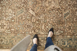 Distressed vintage Heriz carpet showing allover floral design, muted silver, ivory, and powder blue colors.