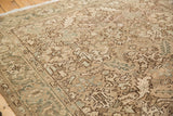 Sprawling floral motifs and distressed texture in muted beige, brown, and soft blue.