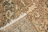 Worn texture and visible foundation of a distressed vintage Heriz carpet corner.