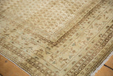 Distressed Mir Sarouk rug corner, faded Mir Boteh pattern, ivory, brown, and dusty blue tones.
