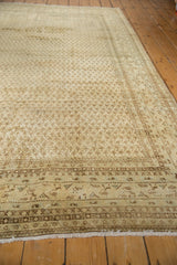 Distressed vintage Mir Sarouk rug with intricate border patterns and visible fringe.