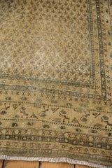 Visible wear, foundation showing, and intricate Mir Boteh design on distressed Mir Sarouk rug.