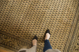 Distressed vintage Mir Sarouk rug showing faint foundation through its Mir Boteh design.