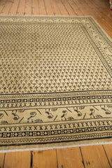 Distressed vintage Mir Sarouk with allover Mir Boteh germinating seeds, mostly even wear, and antique ivory.