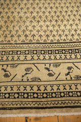 Distressed vintage Mir Sarouk carpet features Mir Boteh and geometric border patterns on antique ivory.