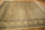Distressed vintage Mir Sarouk carpet detail with worn Mir Boteh design and geometric borders.