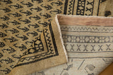 Distressed vintage Mir Sarouk rug pile with faint foundation, folded to reveal hand-knotted backweave patterns.