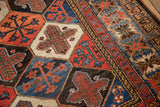 Vintage Baktiari rug detail, garden motif with lattice outlines, madder red, indigo, ivory.