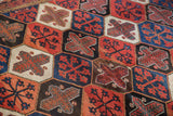 Vintage Baktiari carpet's distinct panel garden motif in madder red, indigo blue, and ivory.