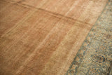 Distressed pale copper and sand field with subtle Herati motif and faded powder blue border.