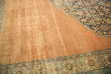 Low pile and abrashes on the distressed pale copper field, contrasting a navy blue Herati motif.