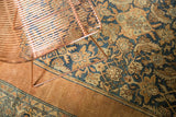 Distressed copper and navy Herati pattern detail on an antique Bibikabad rug with low pile.
