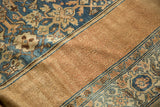 Distressed Bibikabad carpet shows worn Herati pattern in blue, ivory, and textured copper gul.