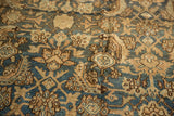Distressed antique Persian Bibikabad displaying intricate Herati and shadow gul motifs in blue and beige.
