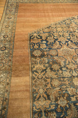Distressed navy Herati pattern meets copper tone-on-tone border on antique Bibikabad rug.
