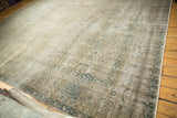 Vintage distressed Sivas carpet corner with faded scrolling vinery, palmettes, and secured edges.