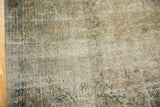 Distressed Sivas carpet detail showing hard wear, faded vinery and palmette motifs.