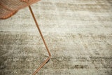 Sivas carpet with softened tones of antique ivory, silver, and charcoal from hard wear.