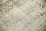 Distressed vintage Sivas carpet texture with muted beige and time-softened charcoal tones.