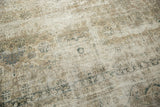 Distressed vintage Sivas rug texture, showing faded scrolling vinery in muted beige and charcoal.