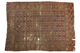 Antique Turkmen carpet with allover 'elephant footprint' gul motifs in wine red, navy, ivory, and scattered wear.
