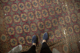 Antique Turkmen carpet, geometric 'elephant footprint' gul motifs, wine red, navy, ivory, visible wear.