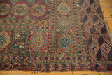 Intricate geometric gul patterns of antique Turkmen rug, tightly woven in wine red and navy.