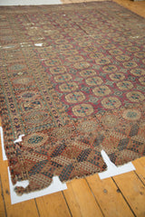 Antique Turkmen carpet with geometric gul motifs, significant holes and splits in wine red.