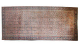 Antique Karabagh carpet, circa 1900, with faded plum Herati field and navy Mahi Mahi border.