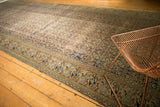 Antique Khorassan carpet's Mahi Mahi border and distressed Herati field in navy and apricot.
