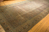 Distressed antique Khorassan carpet with softened Herati field and colorful Mahi Mahi border.