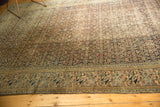 Distressed Khorassan rug detail: Mahi Mahi border alongside allover Herati motif in navy and beige.