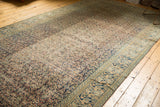 Faded navy and beige Herati motif and Mahi Mahi border on a distressed antique Khorassan rug.