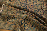 Worn navy blue and sand Mahi Mahi border on an antique distressed Khorassan carpet.