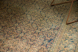 Antique Khorassan rug's distressed Herati motif field and Mahi Mahi border, navy and pale apricot.
