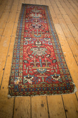 Vintage Heriz runner with cherry red field, sky blue medallions, and time-softened green vinery blossoms.