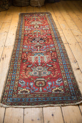 Hand-knotted vintage Heriz runner end, cherry red field, blue-green vinery, bordered motifs, worn fringe.
